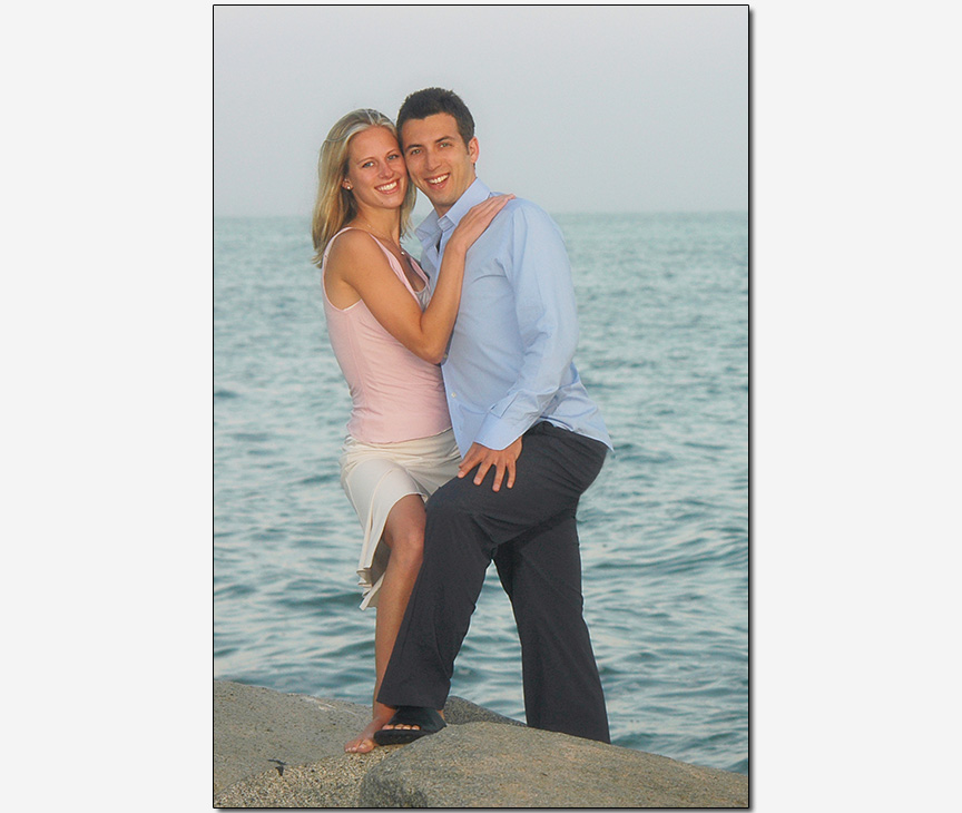 engagement session of an interfaith couple on rocky beach